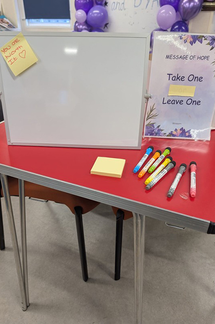 Table and post-it message at the Blossom Project
