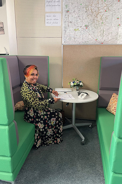 Lady sitting at table as part of wellbeing project